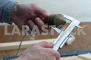 Different construction tools on a wooden background - screwdriver, caliper.