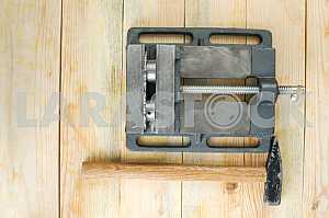 Different construction tools on a wooden background - screwdriver, caliper.