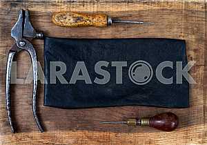 Different construction tools on a wooden background - screwdriver, caliper.