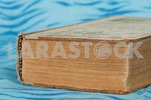 Old and used hardback books or text books on wooden table. Books and reading are essential for self improvement, gaining knowledge and success in our careers, business and personal lives. Copy space