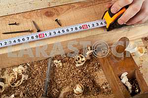 Carpenter tools on wooden table with sawdust. Circular Saw.