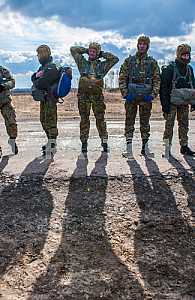 Marines prepare to jump from a helicopter