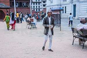 The man in national dress walking down the street.