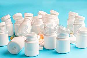Many pills and tablets isolated on light blue background