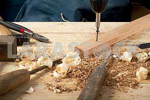 Carpenter tools on wooden table with sawdust. Circular Saw.