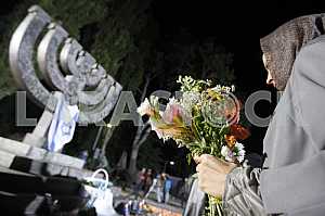 People light candles and lay flowers