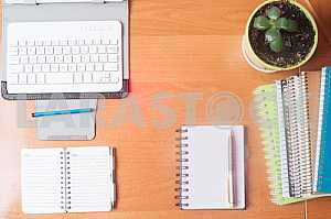 Stack of hardback books on wooden table. Back to school. Copy space. Top view