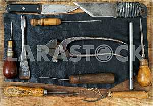 Different construction tools on a wooden background - screwdriver, caliper.