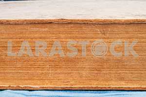 Old and used hardback books or text books on wooden table. Books and reading are essential for self improvement, gaining knowledge and success in our careers, business and personal lives. Copy space