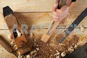 Carpenter tools on wooden table with sawdust. Circular Saw.