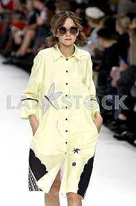 Model in a yellow raincoat demonstrates outfit by Ukrainian designer Larisa Lobanova