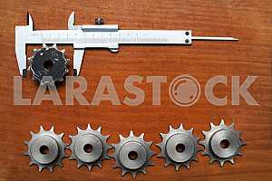 Different construction tools on a wooden background - screwdriver, caliper.