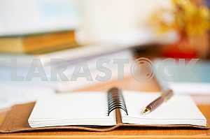 Stack of hardback books on wooden table. Back to school. Copy space. Top view