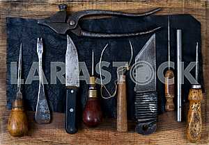 Different construction tools on a wooden background - screwdriver, caliper.