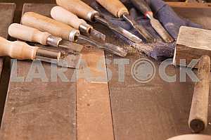 Carpenter tools on wooden table with sawdust. Circular Saw. Carpenter workplace top view