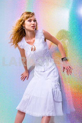 Beautiful Young Woman with bright background. In a white dress
