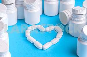 Many pills and tablets isolated on light blue background