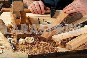 Carpenter tools on wooden table with sawdust. Circular Saw.