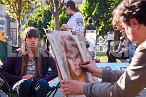 The artist paints a portrait of the street girl