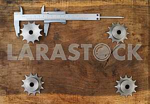 Different construction tools on a wooden background - screwdriver, caliper.