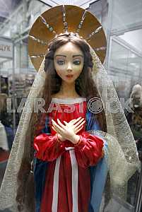 Doll in red and blue dress on the stand