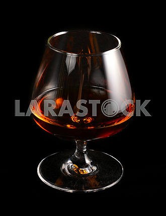 Glass of brandy over black