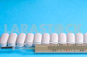 Many pills and tablets isolated on light blue background
