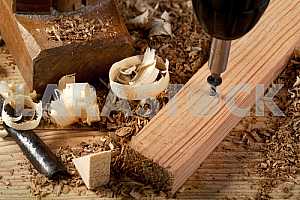 Carpenter tools on wooden table with sawdust. Circular Saw.