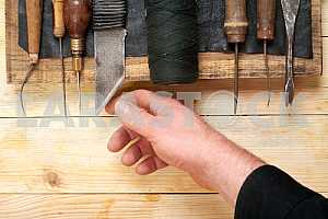 Carpenter tools on wooden table with sawdust. Circular Saw.