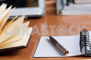 Stack of hardback books on wooden table. Back to school. Copy space. Top view