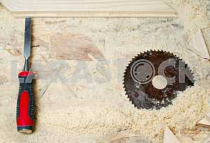 Different construction tools on a wooden background - screwdriver, caliper.