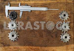 Different construction tools on a wooden background - screwdriver, caliper.