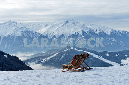 People in a chair on a background of mountains