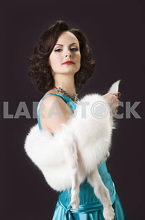 Studio picture of beautiful woman with white fur