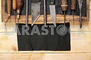 Carpenter tools on wooden table with sawdust. Circular Saw.