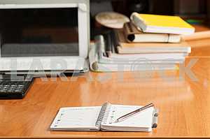Stack of hardback books on wooden table. Back to school. Copy space. Top view