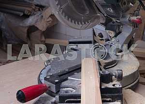 Different construction tools on a wooden background - screwdriver, caliper.