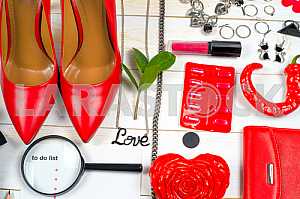 Women clothing set and accessories on white wooden background.