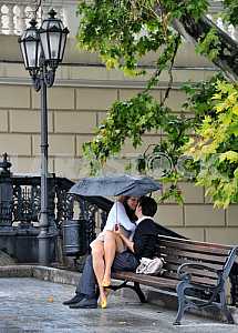 Young couple kissing on a bench