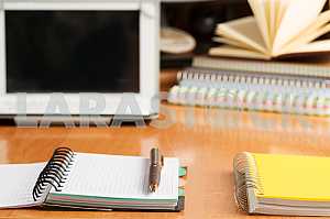 Stack of hardback books on wooden table. Back to school. Copy space. Top view
