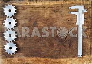 Different construction tools on a wooden background - screwdriver, caliper.