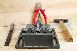Different construction tools on a wooden background - screwdriver, caliper.