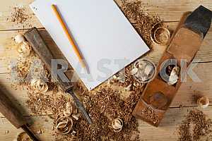 Carpenter tools on wooden table with sawdust. Circular Saw.